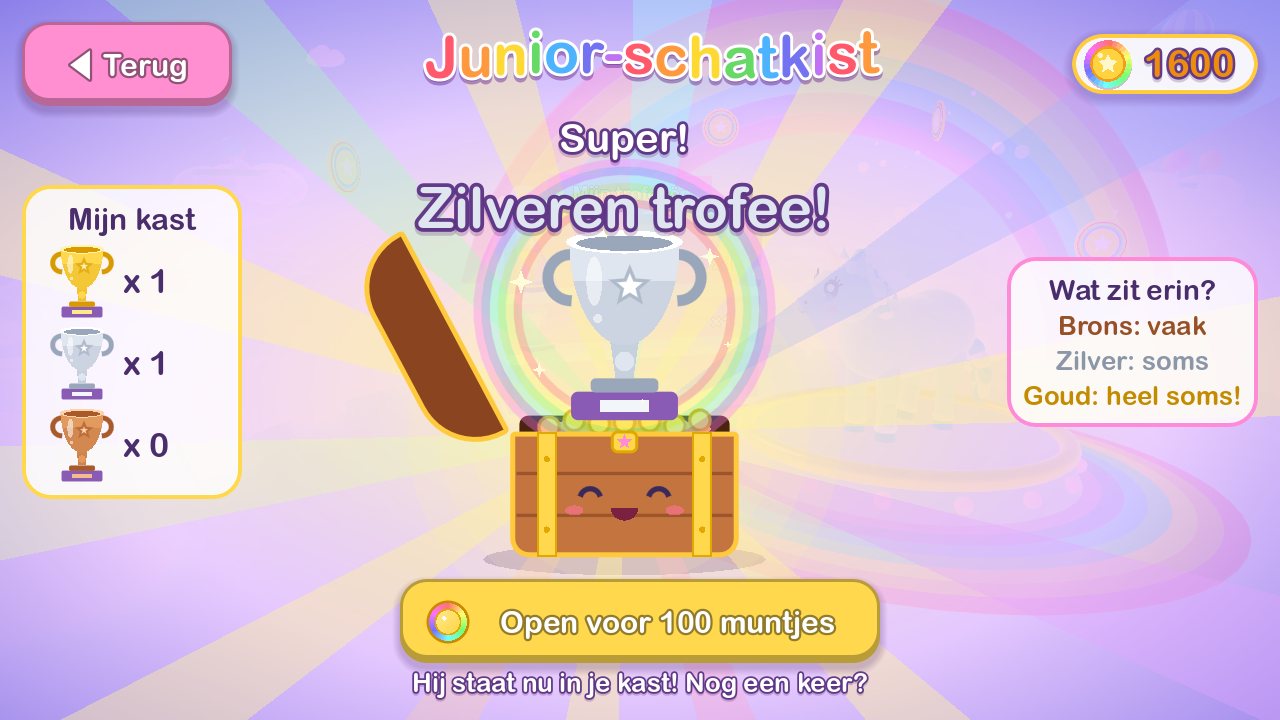 The junior treasure chest, a smiling wooden chest, has just opened and reveals a silver trophy.